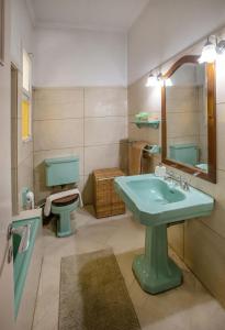 a bathroom with a green sink and a toilet at Vintage apartment KOLONAKI in Athens +28 photos
