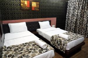 Postel nebo postele na pokoji v ubytování Hotel Pearls