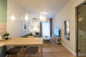 a kitchen and living room with a dining table and a living room at Mandarin apartments by halu! in Thessaloniki