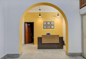 een boog in een hal met een bureau in een kamer bij OYO Home Jaam's Home Stay in Bhubaneshwar
