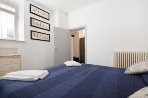 a bedroom with a blue bed with two towels on it at Beach Paradise- Luigi 16 in Levanto