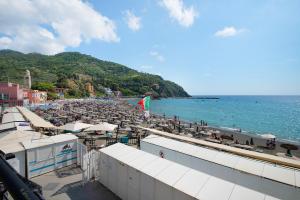 a beach with umbrellas and chairs and the ocean at Beach Paradise- Luigi 16 in Levanto