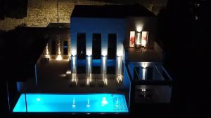 a night view of a building with a swimming pool at Villa Barbara in Adsubia