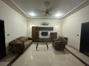 a living room with two couches and a tv at Bahria Town - 10 Marla 2 Bed rooms Portion for families only in Lahore