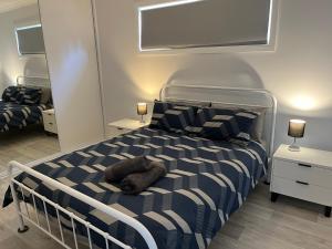 a bedroom with a bed with a stuffed animal on it at Jurien Beachfront Chalets in Jurien Bay