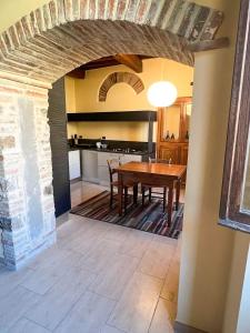 a dining room with a table and a kitchen at Palazzo Collesi in Città di Castello +12 photos
