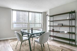 a dining room with a glass table and chairs at River N 2BR w Gym WD nr Magnificent Mile CHI-164 in Chicago