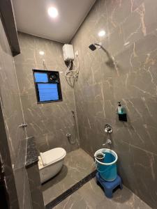 a bathroom with a toilet and a window at Hotel Rahul Regency, Aurangabad in Aurangabad +14 photos