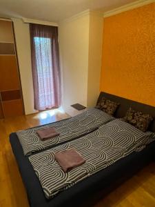 a bedroom with a large bed in a room at IK Apartment in Debrecen