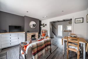 a living room with a couch and a fireplace at East End Cottage - Herriot Country in York