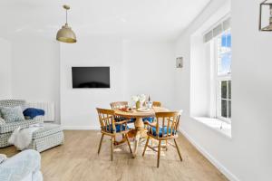 a dining room with a table and chairs at Landau Apartment, Stokenham in Stokenham