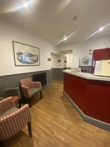 a waiting room with two chairs and a counter at The Post House, Llandudno in Llandudno