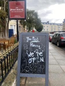 a sign that says the rest house we are open at The Post House, Llandudno in Llandudno