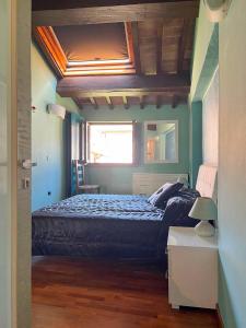 a bedroom with a bed and a window in it at Palazzo Collesi in Città di Castello