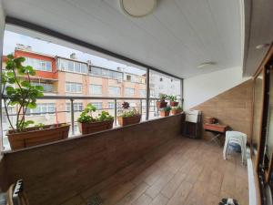 an empty room with potted plants on a balcony at Cozy 3 Room Duplex With Terrace in Istanbul
