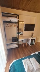 a bedroom with a bed and a desk with a computer at Bujtina 31 in Korçë