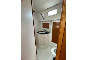 a small bathroom with a toilet and a sink at Sun odyssey 39ib in Corfu Town