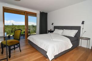 a bedroom with a bed and a table and a chair at Villa Vela Baraka - Happy Rentals in Dragove