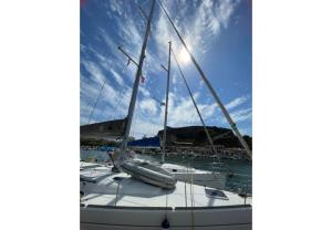 a sailboat docked in a marina with the sun in the sky at S Odyssey 21032i in Corfu Town