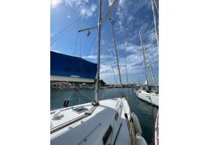 a white sailboat docked in a harbor with other boats at S Odyssey 21032i in Corfu