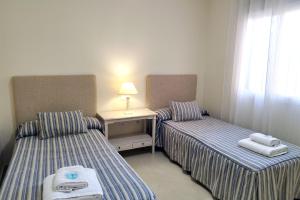 Posteľ alebo postele v izbe v ubytovaní Apartamento Puertosol