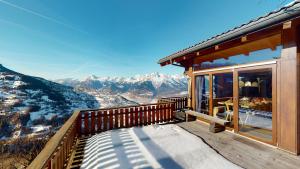 a balcony of a house with a view of mountains at Tschoueilles 5 MOUNTAIN & QUIET chalet 10 pers in Veysonnaz