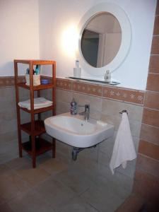 a bathroom with a sink and a mirror at Pine Tree Cottage in Nea Skioni