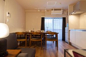 un comedor con mesa y sillas en una habitación en Maison Roppongi, en Tokio