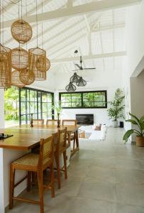 a dining room with a large wooden table and chairs at KALAVA VILLA in Ahangama