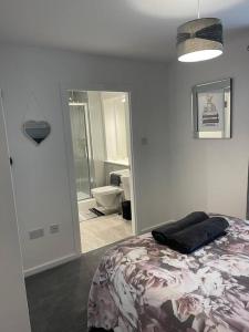 a bedroom with a bed and a bathroom with a mirror at A glimpse of the championship in Carnoustie