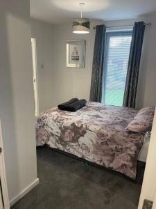 a bedroom with a bed and a window at A glimpse of the championship in Carnoustie