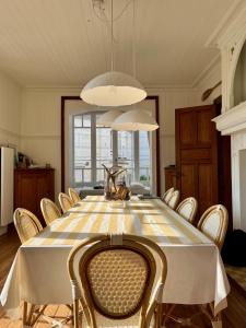 a dining room with a large table and chairs at Villa La Rafale plage centre 300 m in Le Touquet-Paris-Plage