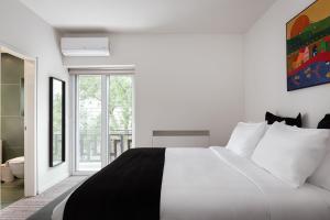 a white bedroom with a black and white bed at Glyfada Unique Residence in Athens