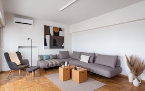 a living room with a couch and two chairs at Glyfada Unique Residence in Athens