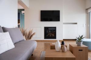 a living room with a couch and a table at Glyfada Unique Residence in Athens