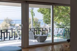 a screened porch with chairs and a view of the ocean at Glyfada Unique Residence in Athens +27 photos