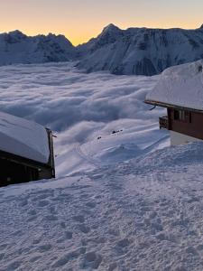 a building on top of a mountain covered in snow at Nido Alpino Fiescheralp in Fiesch