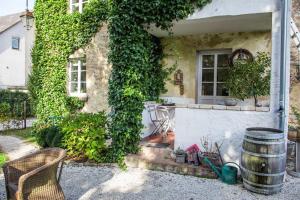 a house with ivy growing on the side of it at Ferienwohnung Wagner in Saarburg