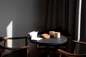 a small black table with two cups on it at Bob W Amsterdam Noord in Amsterdam +73 photos