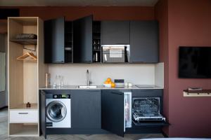 a kitchen with a washing machine and a sink at Bob W Amsterdam Noord in Amsterdam
