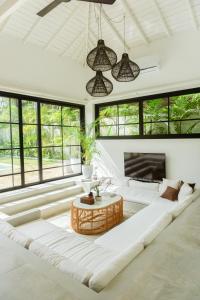 a living room with a large couch and a table at KALAVA VILLA in Ahangama