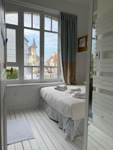 a bedroom with a bed in front of a window at Villa La Rafale plage centre 300 m in Le Touquet-Paris-Plage