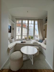 a living room with a table and a large window at Villa La Rafale plage centre 300 m in Le Touquet-Paris-Plage +22 photos