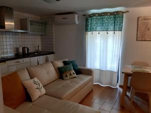 a living room with a couch in front of a window at Casa Bajo la Roca in Setenil