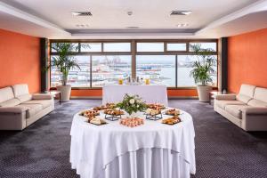 a large room with a table with food on it at Hotel Cristina by Tigotan Las Palmas - Adults Only in Las Palmas de Gran Canaria