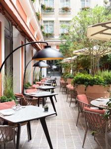 a row of tables and chairs on a patio at Hôtel Le Royal Monceau Raffles Paris in Paris