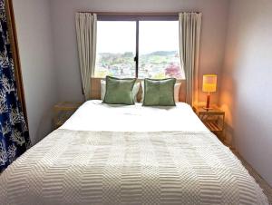 A bed or beds in a room at Mountain View Totoro - spacious & sunny