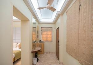 a skylight in a bedroom with a ceiling fan at Regent Hotel in Mumbai