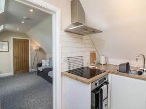 a kitchen with a sink and a stove at Spicery Barn Loft in Exeter +9 photos
