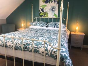 a bedroom with a bed with a blue and white comforter at Seaham in Weymouth